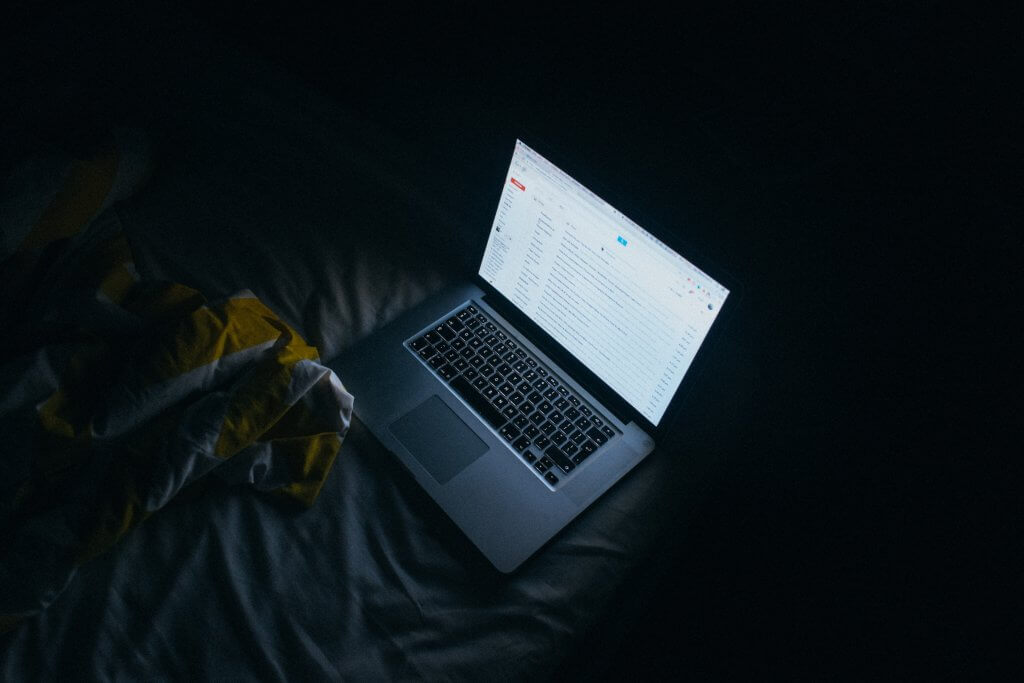 Glare from laptop in a dark room.