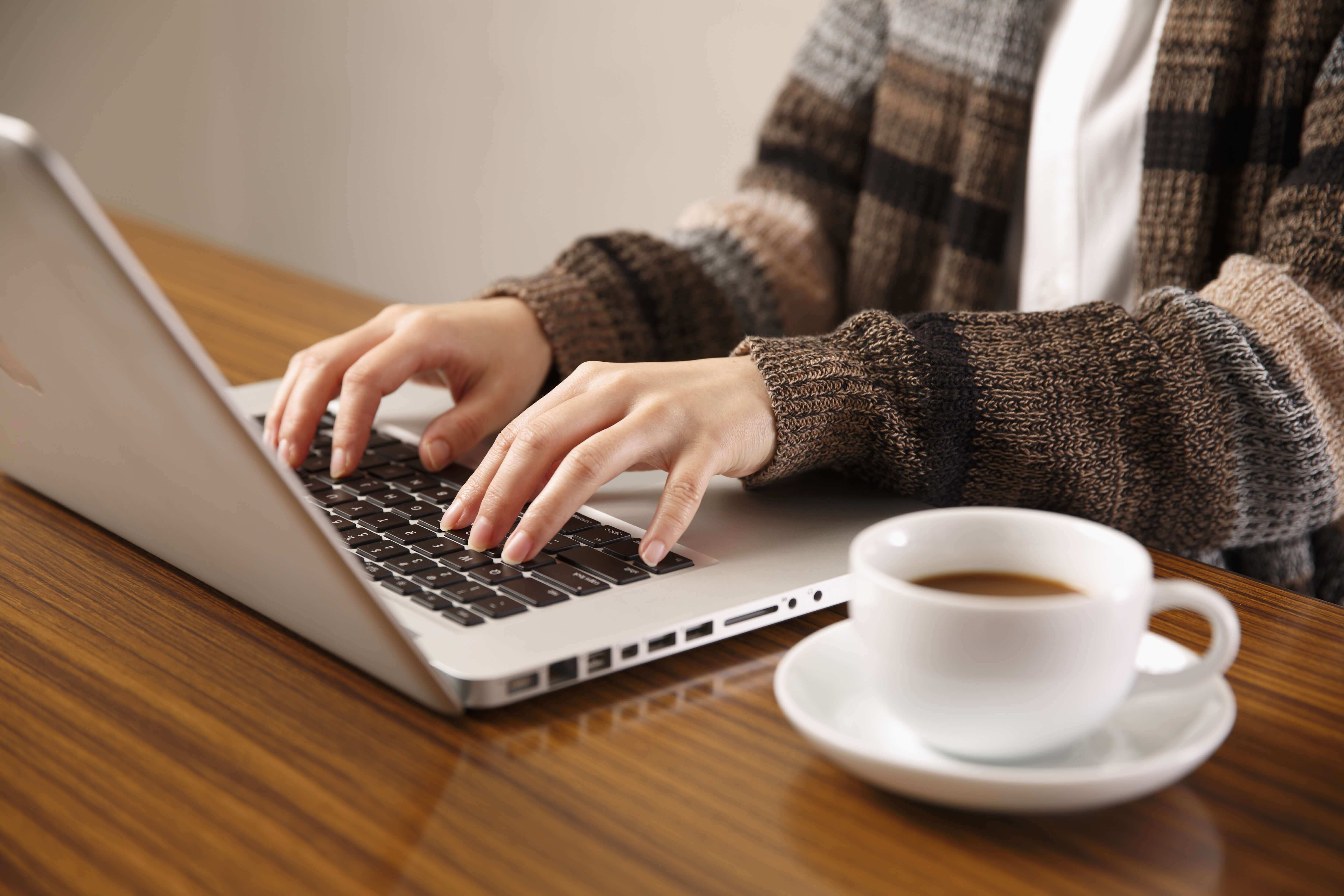 Freelancer writing proposal on the laptop at home