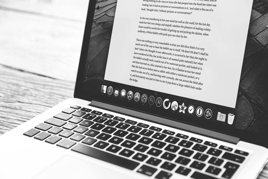 Freelance writer. Mac with an open document across the screen.